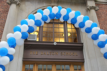 Photo of a balloon rainbow over the Dalton School doorway.