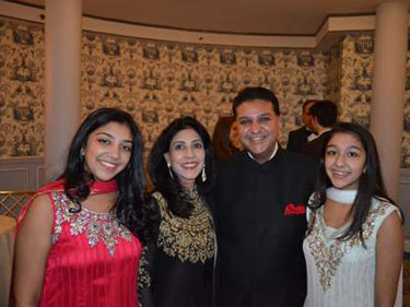 Deepti and Suneet Mittal with their daughters. Links to their story