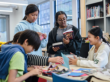 Students in a library. Links to Gifts of Cash, Checks, and Credit Cards